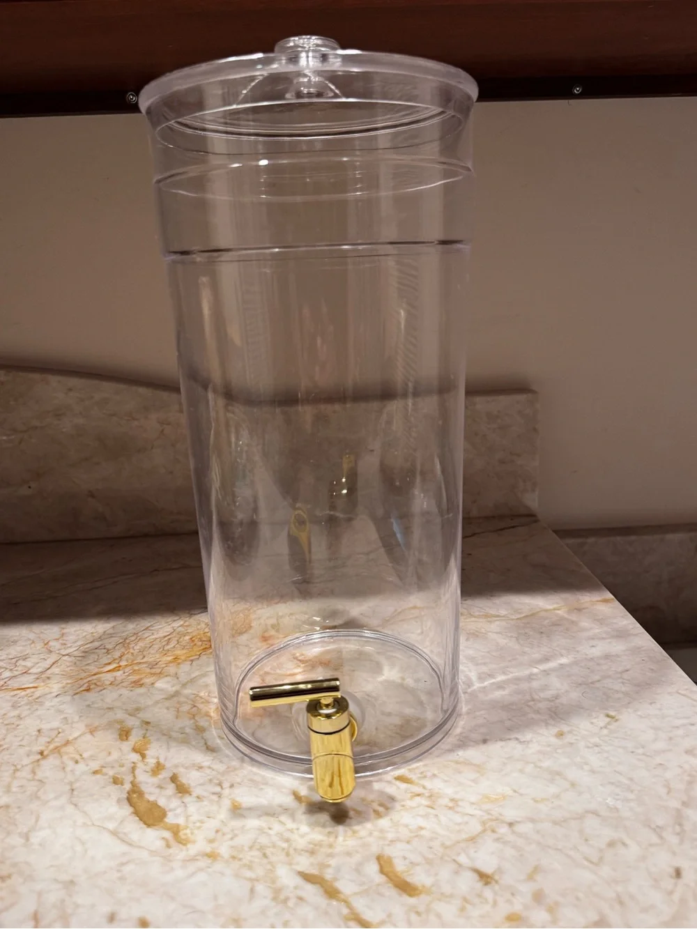 Clear 1.6 gallon Acrylic Beverage Dispenser with Gold Spigot. 14” H x 7” W.
